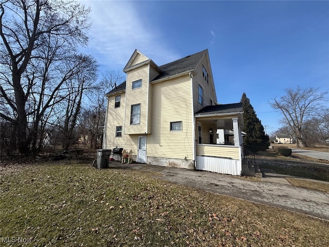 view of side of home with driveway