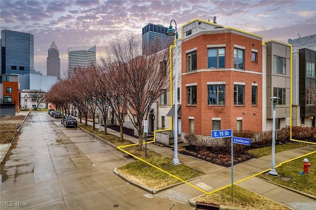 property at dusk featuring a view of city