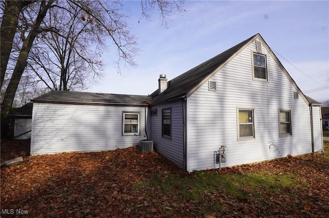 rear view of property with a chimney