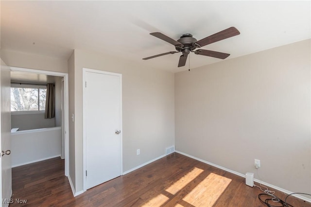 unfurnished bedroom featuring visible vents, baseboards, and wood finished floors