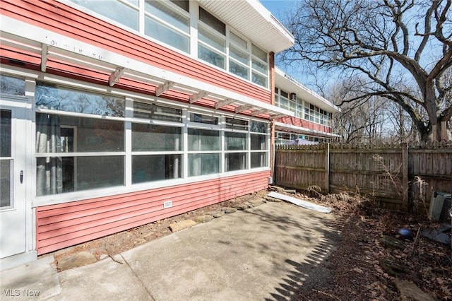 view of side of home with fence