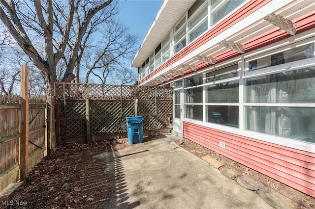 view of side of home featuring fence private yard and a patio area