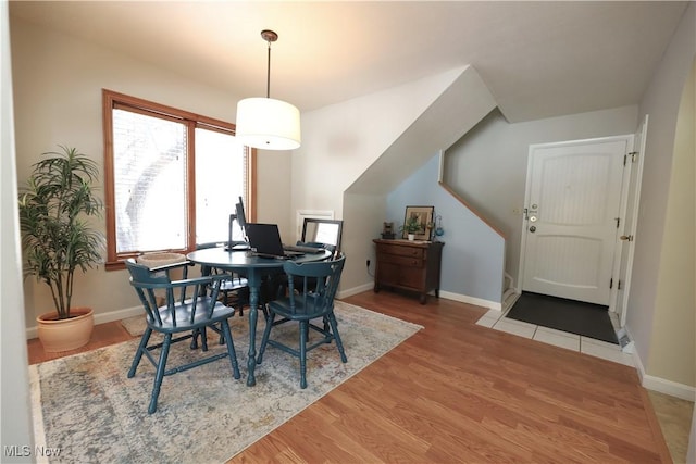 dining area featuring wood finished floors and baseboards