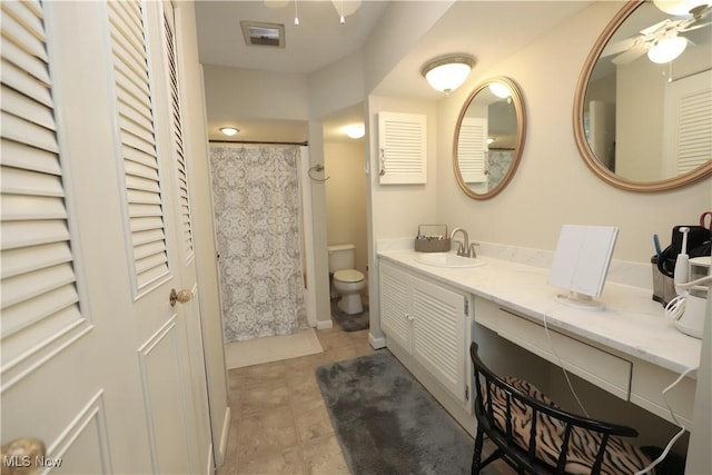 bathroom with vanity, a shower with curtain, a ceiling fan, tile patterned flooring, and toilet