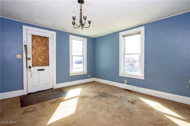 interior space with visible vents, baseboards, a notable chandelier, and carpet flooring