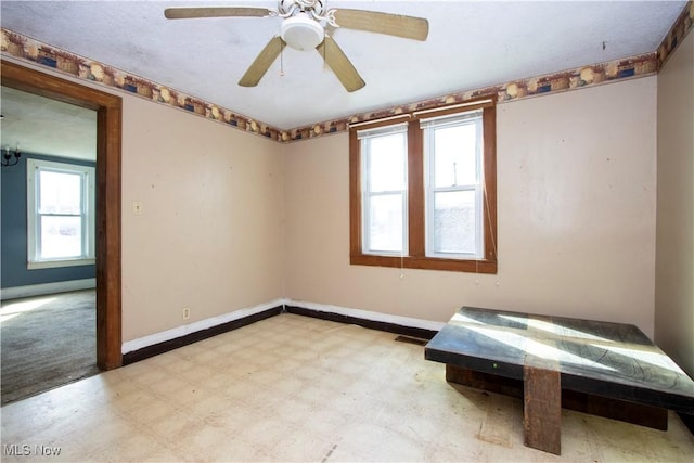 unfurnished bedroom with tile patterned floors, visible vents, baseboards, and a ceiling fan