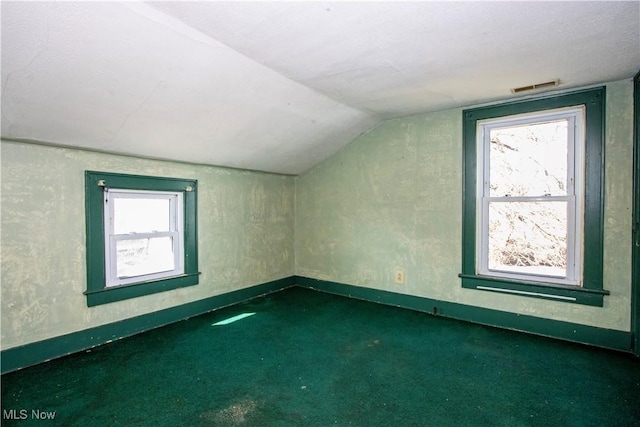 bonus room featuring visible vents, lofted ceiling, baseboards, and carpet flooring