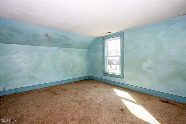 additional living space with lofted ceiling and carpet