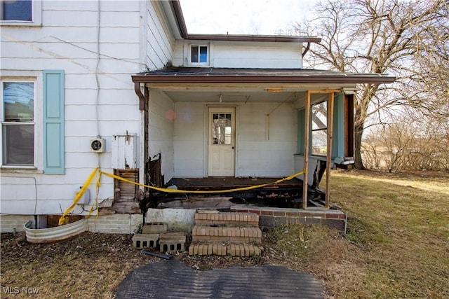 entrance to property with a lawn