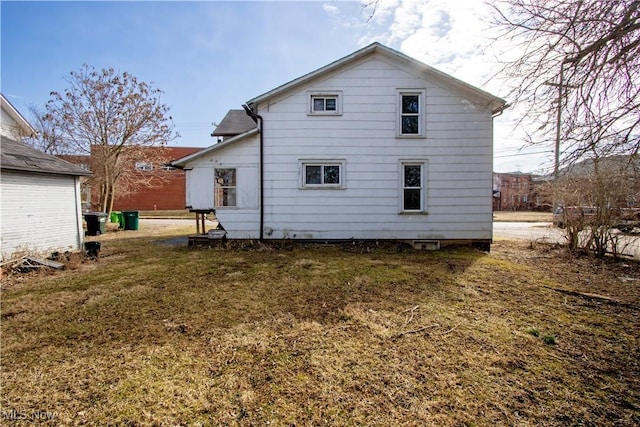 back of property featuring a lawn