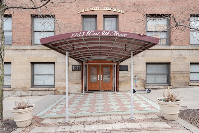 entrance to property featuring brick siding and french doors