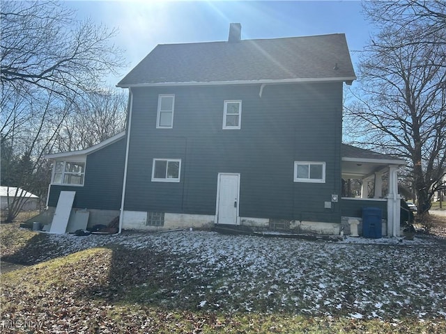 view of home's exterior featuring a chimney and a shingled roof