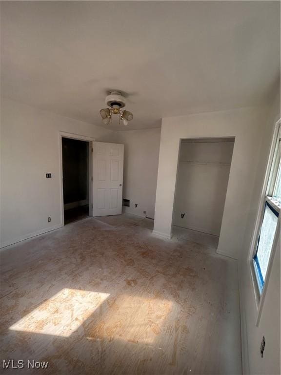 unfurnished room with baseboards