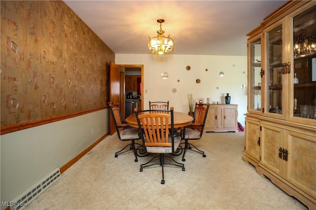 dining room featuring light carpet, a chandelier, baseboards, and visible vents