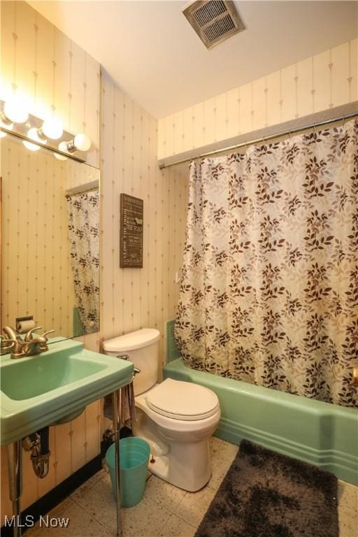 full bathroom with wallpapered walls and visible vents