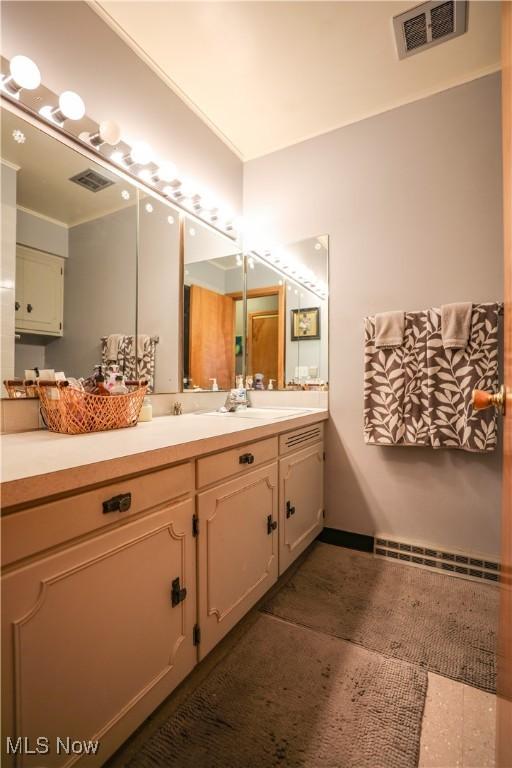 bathroom with tile patterned floors, visible vents, and vanity