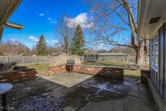 view of patio / terrace featuring a trampoline and a fenced backyard