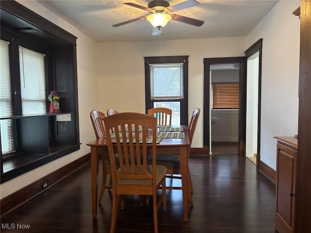 dining area featuring baseboards, dark wood-type flooring, and a ceiling fan