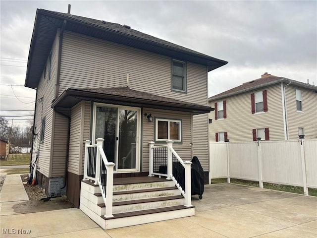 back of house with fence