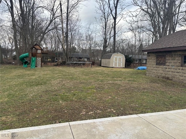 view of yard with a playground, an outbuilding, and a shed