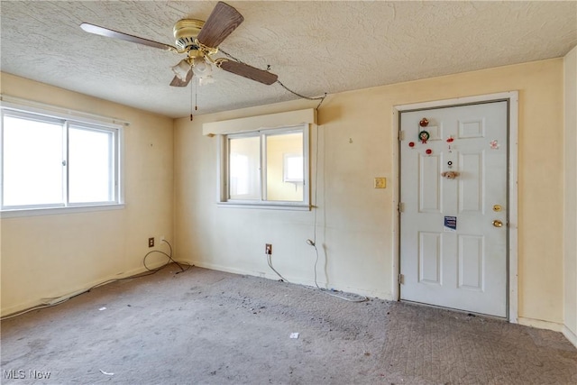 interior space featuring a textured ceiling and ceiling fan