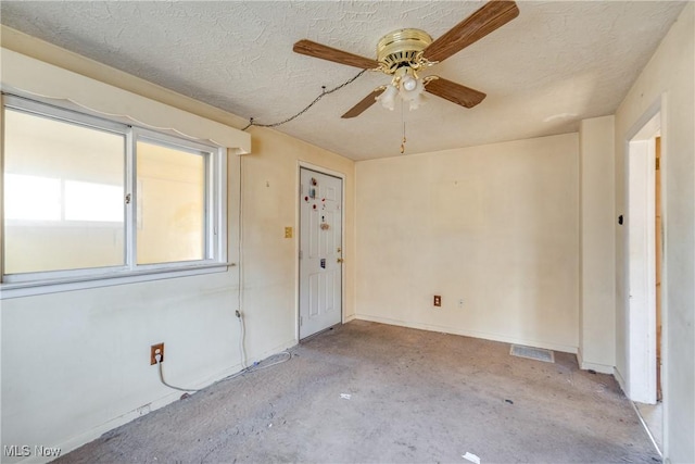 unfurnished room featuring baseboards, a textured ceiling, and a ceiling fan