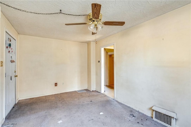 unfurnished room featuring visible vents, unfinished concrete floors, a textured ceiling, and a ceiling fan