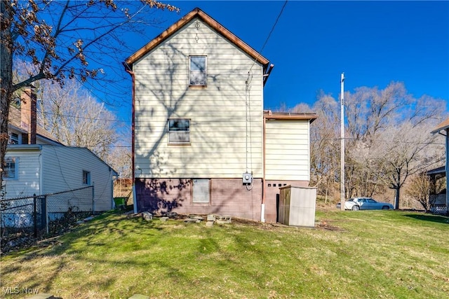 view of property exterior with a yard and fence