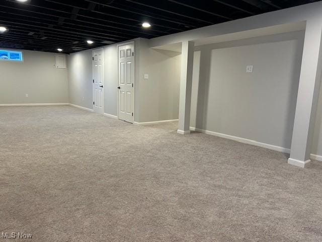 finished basement featuring carpet and baseboards