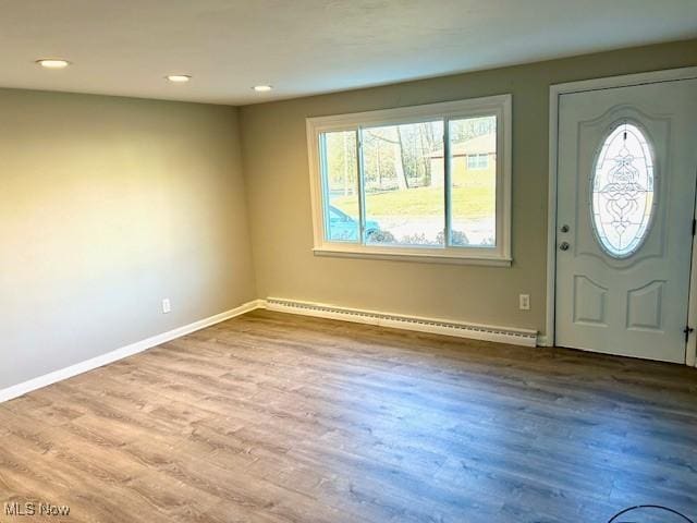 entryway with recessed lighting, a baseboard radiator, baseboards, and wood finished floors