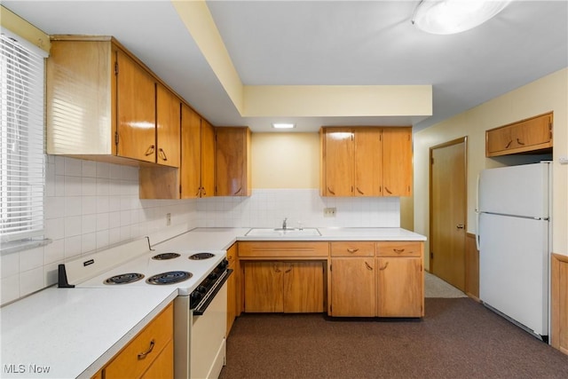 kitchen with white appliances, light countertops, backsplash, and a sink