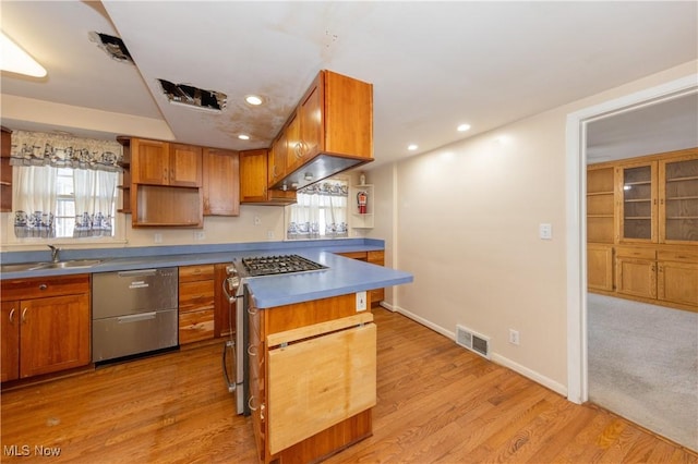 kitchen with dishwashing machine, gas stove, visible vents, open shelves, and a sink