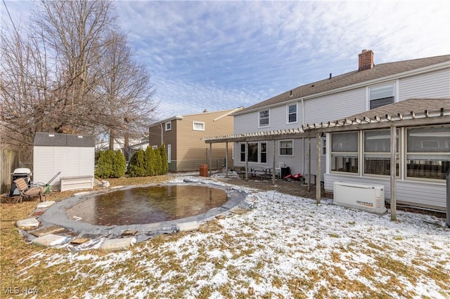 back of house featuring an outbuilding, a storage unit, a pergola, and a patio