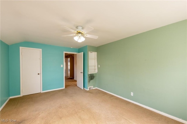 unfurnished bedroom featuring visible vents, baseboards, light colored carpet, and ceiling fan