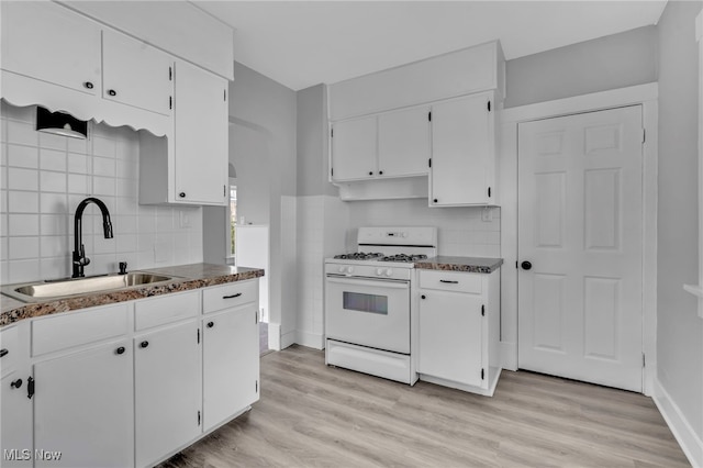 kitchen with light wood-style flooring, white cabinetry, white range with gas stovetop, and a sink