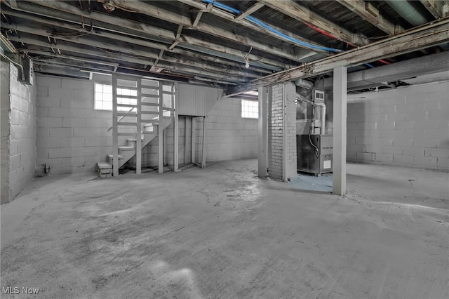 basement with heating unit and a wealth of natural light