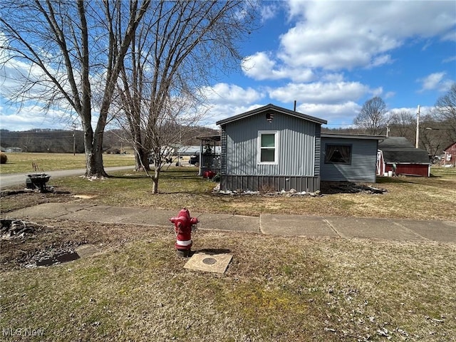 view of side of property with a lawn