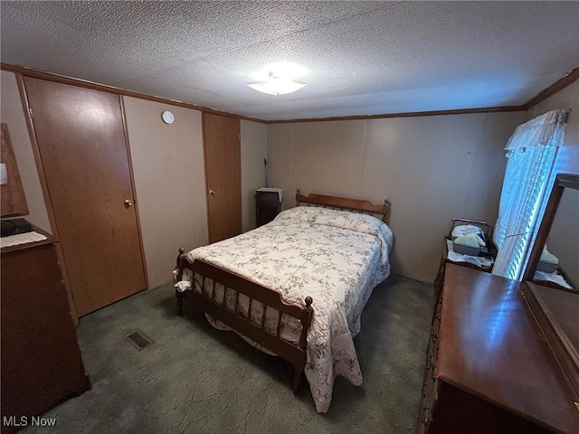 carpeted bedroom featuring visible vents and a textured ceiling