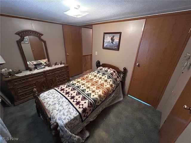 carpeted bedroom featuring a textured ceiling