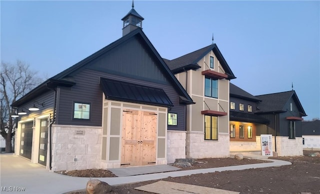 view of building exterior with an attached garage and driveway