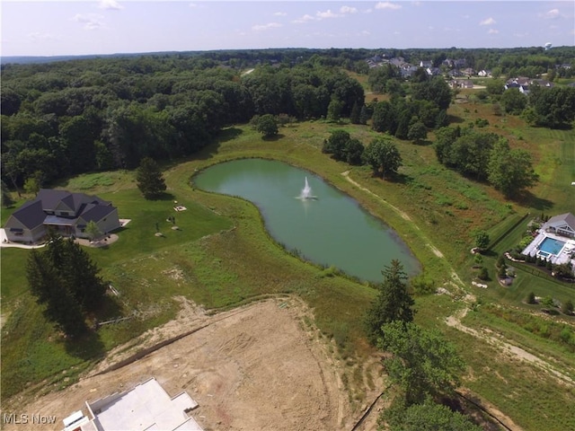 drone / aerial view featuring a view of trees and a water view