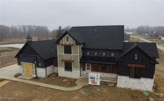 view of front of property with roof with shingles