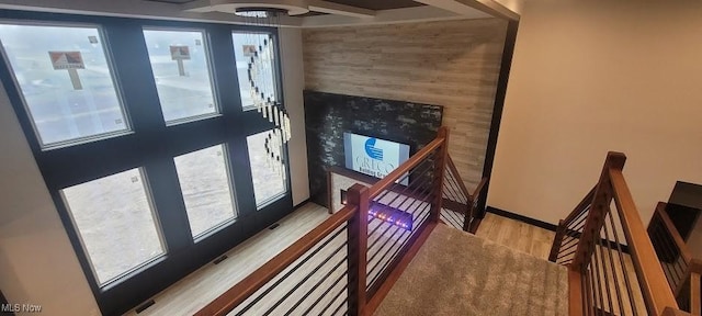 staircase with plenty of natural light, baseboards, and wood finished floors