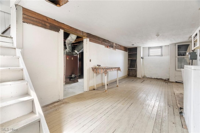 basement with hardwood / wood-style flooring