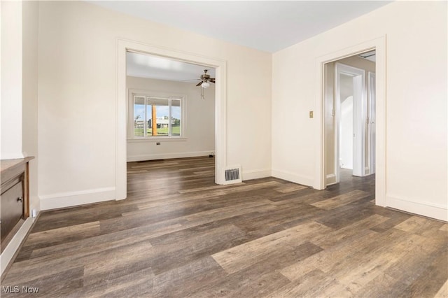 empty room featuring visible vents, baseboards, wood finished floors, and a ceiling fan