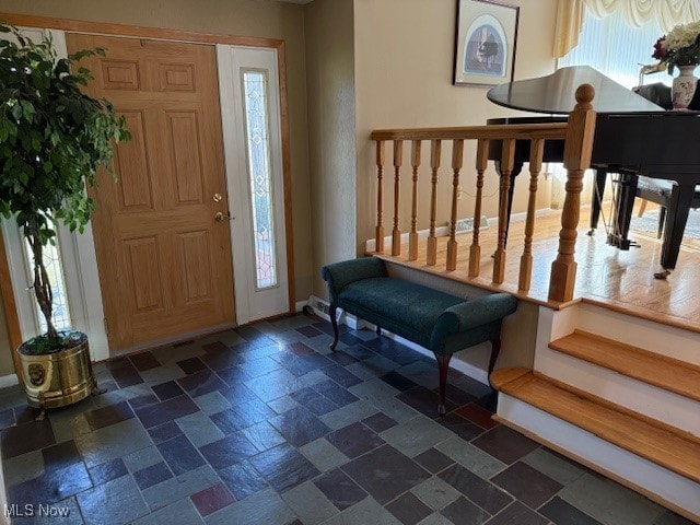 entryway with stone tile flooring and a healthy amount of sunlight