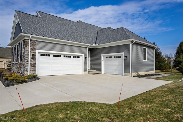 view of side of home featuring stone siding, concrete driveway, a shingled roof, and a garage