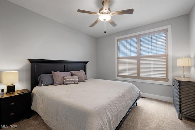 bedroom with baseboards, carpet floors, lofted ceiling, and a ceiling fan