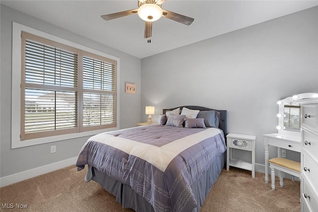 carpeted bedroom featuring baseboards and ceiling fan