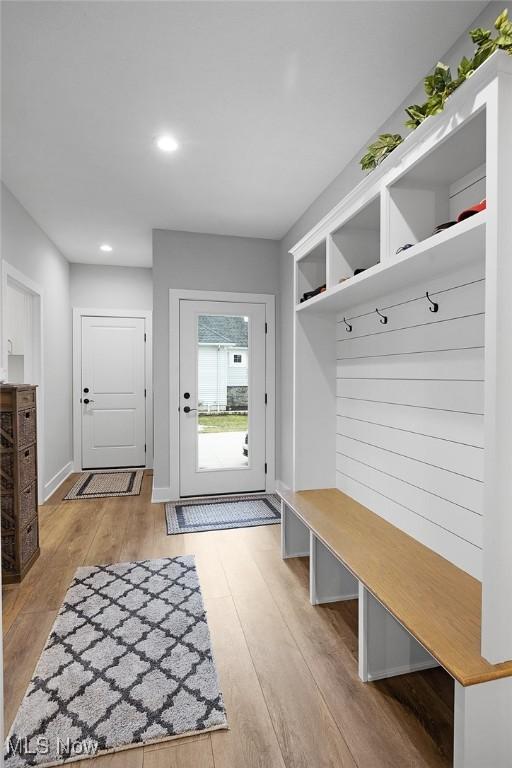 mudroom with recessed lighting, light wood-style floors, and baseboards